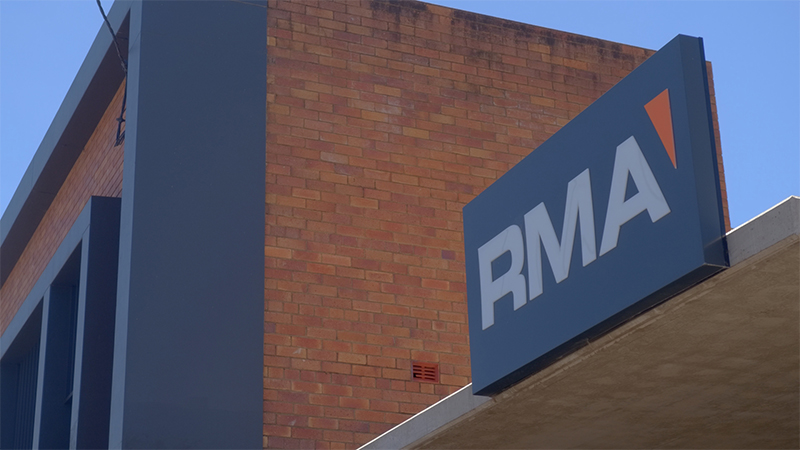 A brick building with the RMA Soils + Geotechnical logo on an outdoor business sign