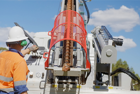 A geotechnical engineer using a mobile drill rig on site after reverse scoping a construction project