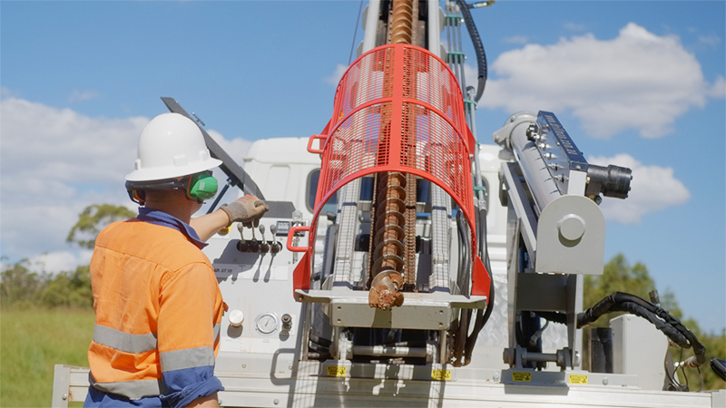 A geotechnical engineer using a mobile drill rig on site after reverse scoping a construction project